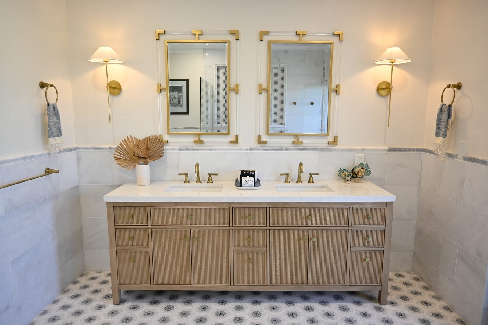 Bird of Paradise ensuite — double vanity with gold fixtures and walk-in shower