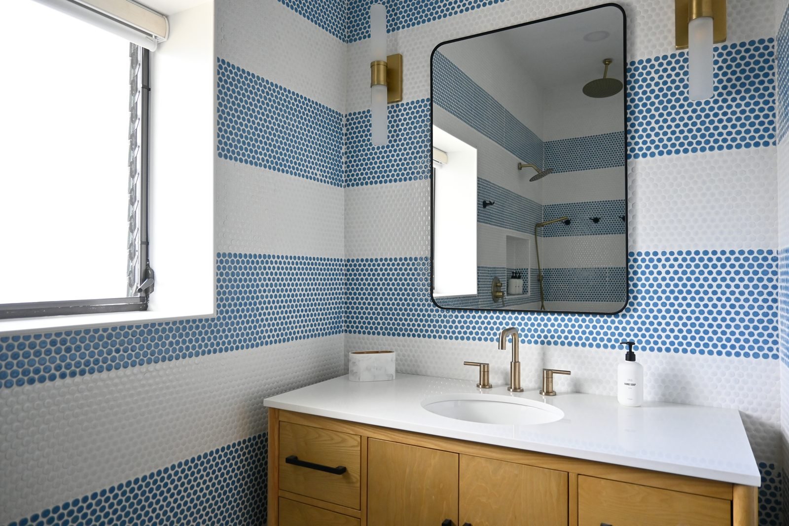 Bunk room bathroom vanity with blue penny tile