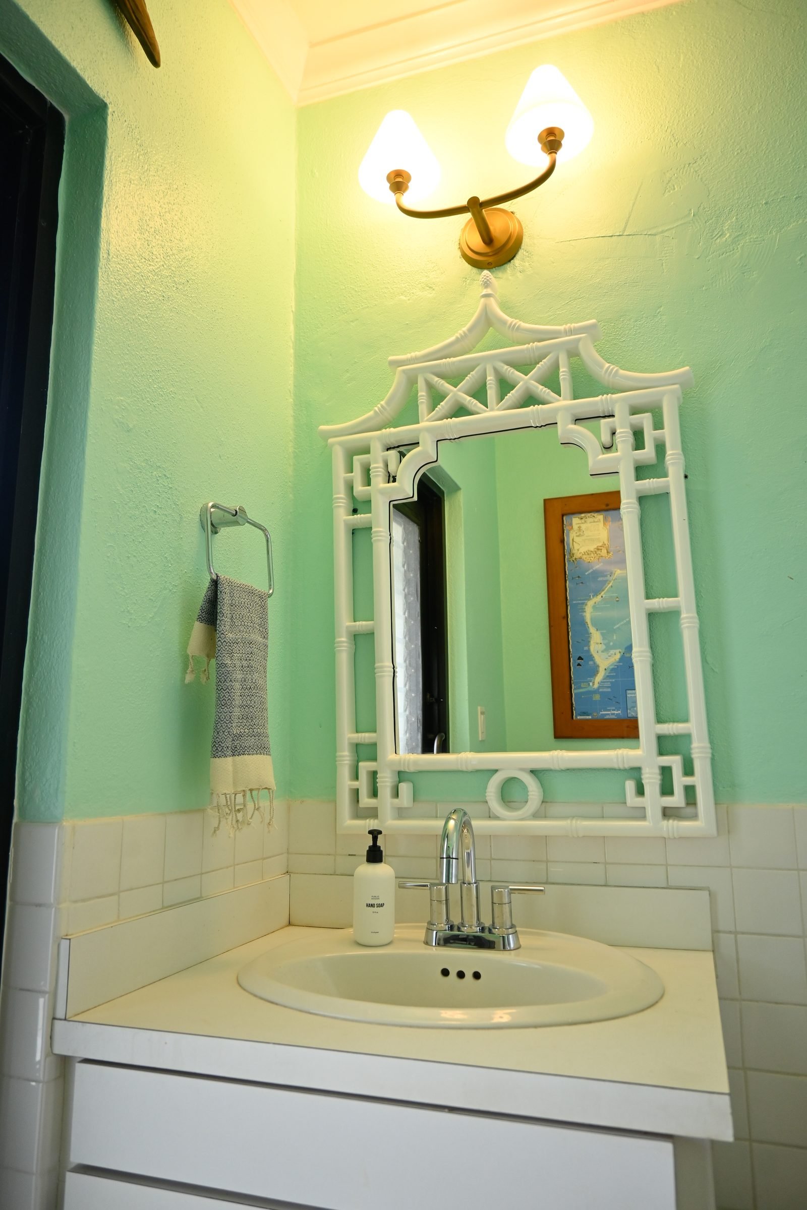 Guest bathroom off the Great Room — mint green vanity with ornate mirror