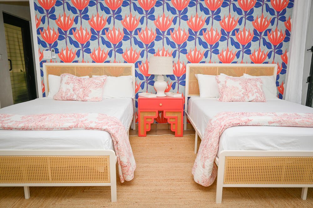 Twin beds with coral fan wallpaper